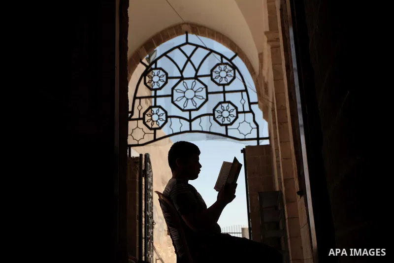 A Palestinian muslim reads the holy Qur'an at mosque in Gaza city, on June 30, 2014. Muslims around the world refrain from eating, drinking and sexual intercourse from dawn till dusk during Ramadan, the holiest month in...