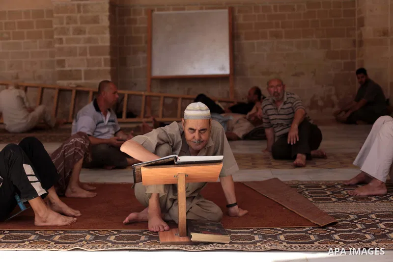 A Palestinian muslim reads the holy Qur'an at mosque in Gaza city, on June 30, 2014. Muslims around the world refrain from eating, drinking and sexual intercourse from dawn till dusk during Ramadan, the holiest month in...