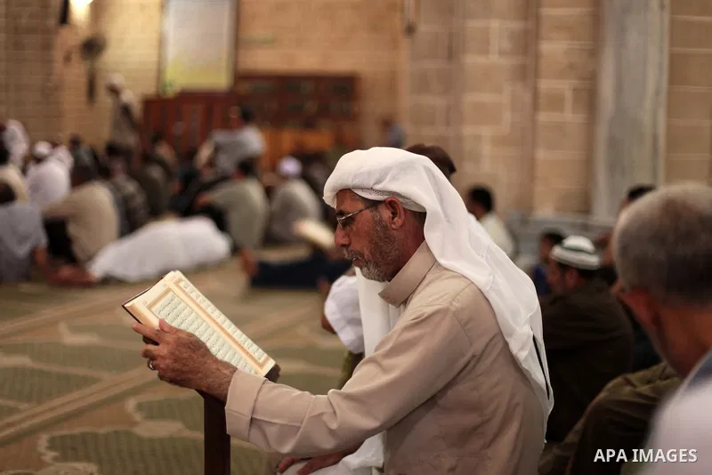 A Palestinian muslim reads the holy Qur'an at mosque in Gaza city, on June 30, 2014. Muslims around the world refrain from eating, drinking and sexual intercourse from dawn till dusk during Ramadan, the holiest month in...