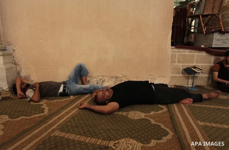 Palestinian muslims sleep at mosque during the Muslims fasting month of Ramadan in Gaza city, on June 30, 2014. Muslims around the world refrain from eating, drinking and sexual intercourse from dawn till dusk during Ram...