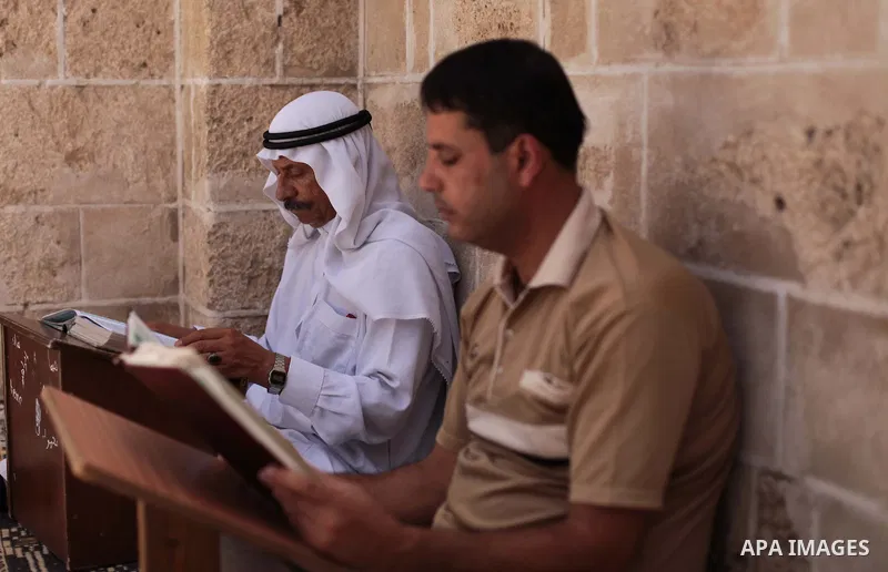 Palestinian muslims read the holy Qur'an at mosque in Gaza city, on June 30, 2014. Muslims around the world refrain from eating, drinking and sexual intercourse from dawn till dusk during Ramadan, the holiest month in th...