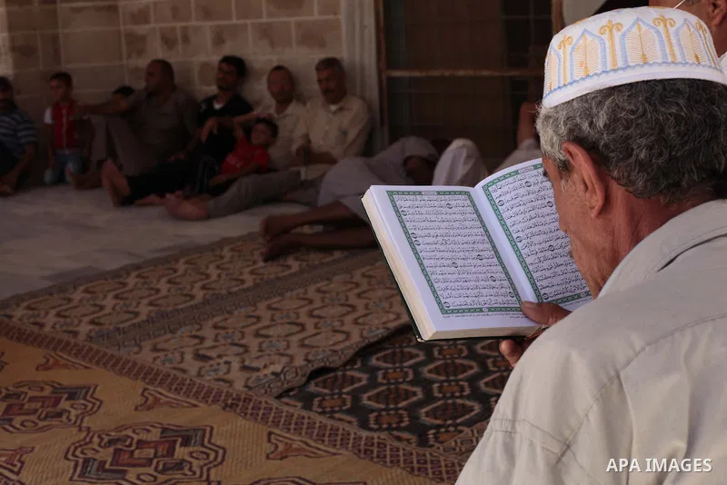 A Palestinian muslim reads the holy Qur'an at mosque in Gaza city, on June 30, 2014. Muslims around the world refrain from eating, drinking and sexual intercourse from dawn till dusk during Ramadan, the holiest month in...