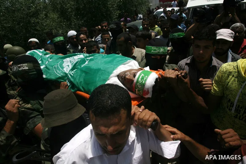 Palestinian members of Hamas' armed wing carry the body of their comrade Mohammed Ebeid during his funeral in Deir El-Balah in the central Gaza Strip June 30, 2014. Israeli forces attacked militant targets in the Gaza St...