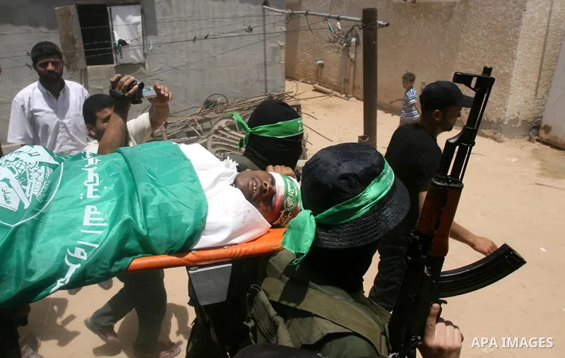 Palestinian members of Hamas' armed wing carry the body of their comrade Mohammed Ebeid during his funeral in Deir El-Balah in the central Gaza Strip June 30, 2014. Israeli forces attacked militant targets in the Gaza St...