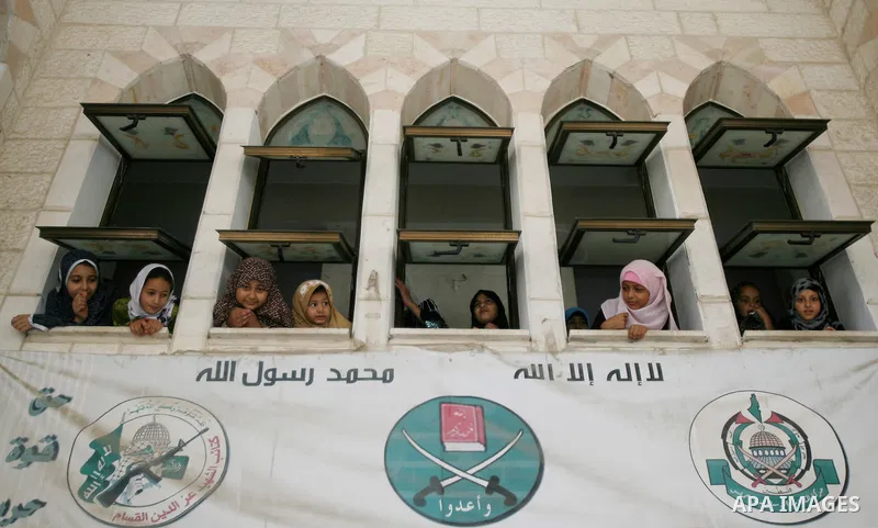 Palestinian girls look at the body of a Hamas gunman Mohammed Ebeid during his funeral in Deir El-Balah in the central Gaza Strip June 30, 2014. Israeli forces attacked militant targets in the Gaza Strip on Sunday, killi...