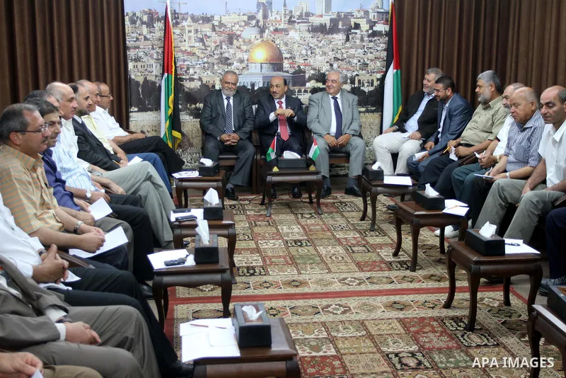 Palestinian ministers of unity government in Gaza Strip meet with members from the various Palestinian factions, at the headquarters of the Council of Ministers, in Gaza City on June 30, 2014. Photo by Mohammed Asad