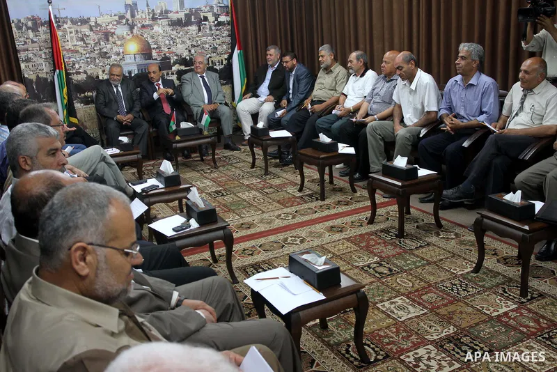 Palestinian ministers of unity government in Gaza Strip meet with members from the various Palestinian factions, at the headquarters of the Council of Ministers, in Gaza City on June 30, 2014. Photo by Mohammed Asad
