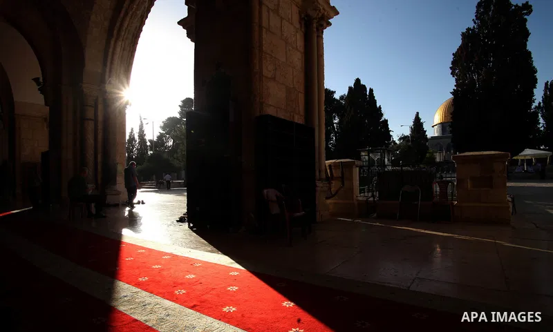 Palestinian muslims walk outside al-Aqsa mosque, Islam's third holiest site, during the holy fasting month of Ramadan, in Jerusalem's Old City on June 30, 2014. Muslim believers abstain from eating, drinking, smoking and...