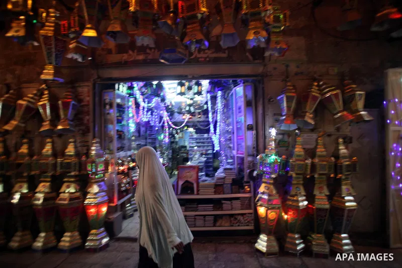 A Palestinian woman walks at a market outside al-Aqsa mosque, Islam's third holiest site, during the holy fasting month of Ramadan, in Jerusalem's Old City on June 30, 2014. Muslim believers abstain from eating, drinking...