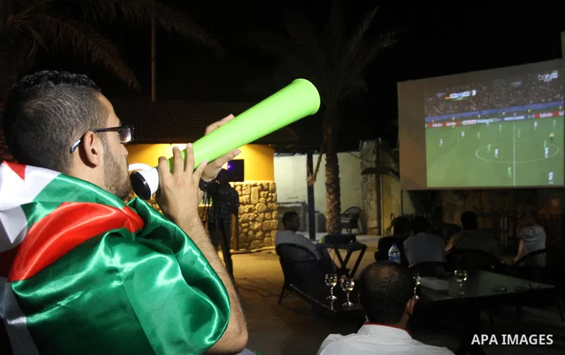 Palestinian supporters of the Algerian World Cup team watch the Brazil FIFA World Cup 2014 round of 16 match between Algeria and Germany in Gaza City on June 30, 2014. Photo by Mohammed Asad
