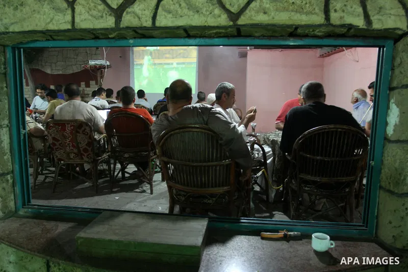 Algerian members of the 'Miles of Smiles' aid convoy, watch the Brazil FIFA World Cup 2014 round of 16 match between Algeria and Germany in Gaza City on June 30, 2014. Photo by Mohammed Asad