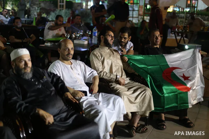 Algerian members of the 'Miles of Smiles' aid convoy, watch the Brazil FIFA World Cup 2014 round of 16 match between Algeria and Germany in Gaza City on June 30, 2014. Photo by Mohammed Asad