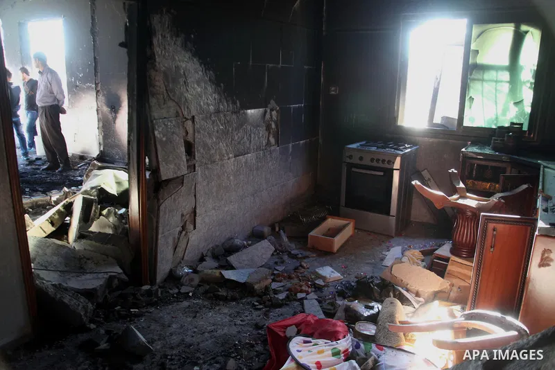 Palestinian men inspect the house of Amer Abu Eishe, a member of the Islamist Hamas in Hebron named by Israel as one of the two prime suspects in the murder of three kidnapped Israeli teenagers on July 1, 2014 in the Wes...