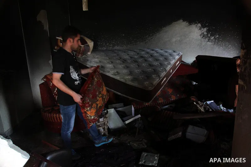 A Palestinian man inspects the house of Amer Abu Eishe, a member of the Islamist Hamas in Hebron named by Israel as one of the two prime suspects in the murder of three kidnapped Israeli teenagers on July 1, 2014 in the...