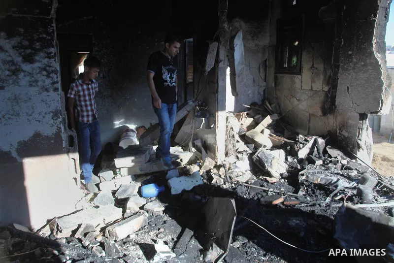 Palestinian men inspect the house of Amer Abu Eishe, a member of the Islamist Hamas in Hebron named by Israel as one of the two prime suspects in the murder of three kidnapped Israeli teenagers on July 1, 2014 in the Wes...