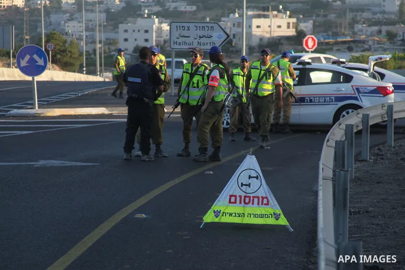 Members of Israeli security forces stand next to their vehicles as they block the northern entrance of Halhul village, near the West Bank city of Hebron, on June 30, 2014. Earlier Monday the bodies of the three kidnapped...
