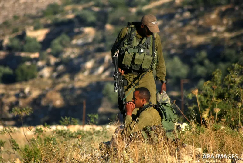 Israeli soldiers keep guard near the West Bank city of Hebron July 1, 2014. Israeli aircraft bombed dozens of sites in the Gaza Strip on Tuesday, the military said, and troops opened fire and killed a Palestinian during...