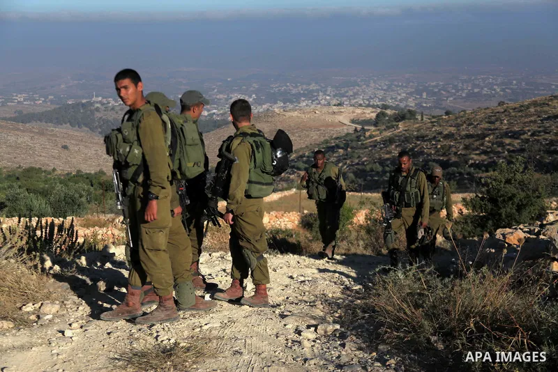 Israeli soldiers keep guard near the West Bank city of Hebron July 1, 2014. Israeli aircraft bombed dozens of sites in the Gaza Strip on Tuesday, the military said, and troops opened fire and killed a Palestinian during...