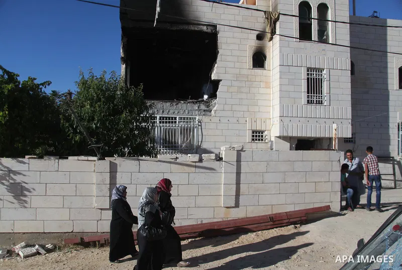 Relatives gather outside the house of Amer Abu Eishe, a member of the Islamist Hamas in Hebron named by Israel as one of the two prime suspects in the murder of three kidnapped Israeli teenagers on July 1, 2014 in the We...