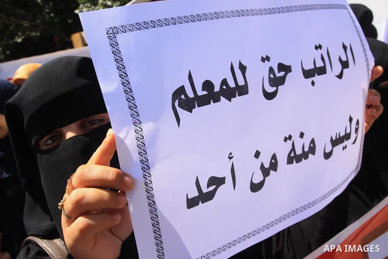 Palestinian Teachers hold placards during a protest against not receiving their salaries, in Gaza City on July 01, 2014. Many issues involving the Strip, such as the fate of former employees of the Hamas government, have...
