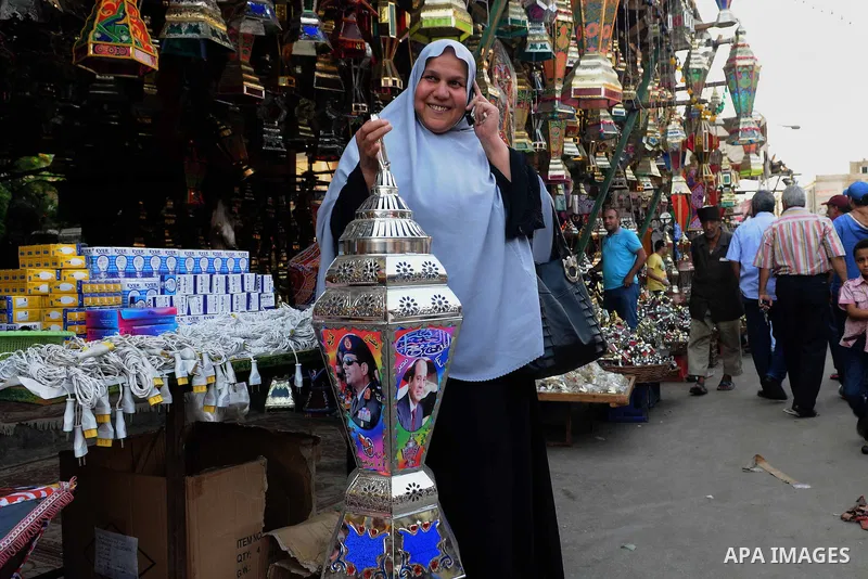 An Egyptian woman chooses traditional lanterns used for the holy month of Ramadan at a market in Cairo, Egypt, July 01, 2014. Muslim believers abstain from eating, drinking, smoking and having sex from dawn until sunset....