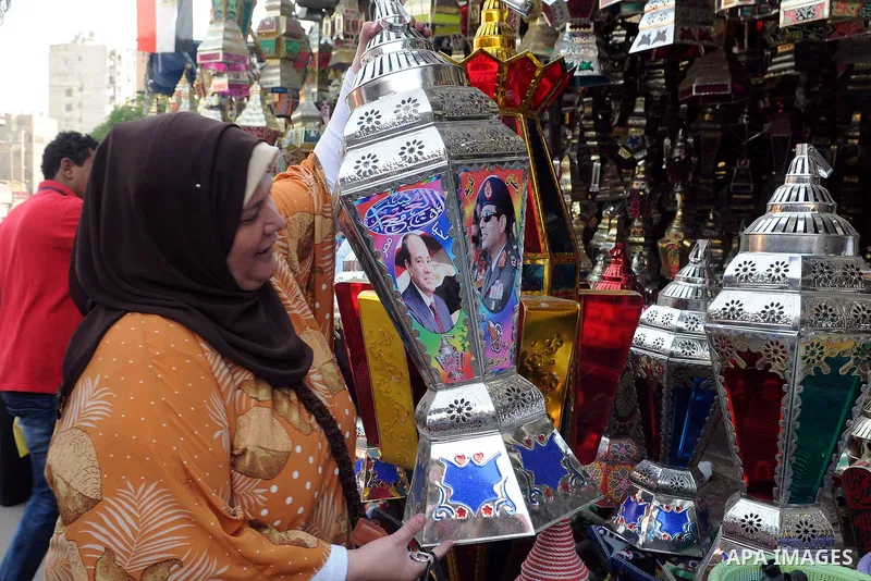 An Egyptian woman chooses traditional lanterns used for the holy month of Ramadan at a market in Cairo, Egypt, July 01, 2014. Muslim believers abstain from eating, drinking, smoking and having sex from dawn until sunset....