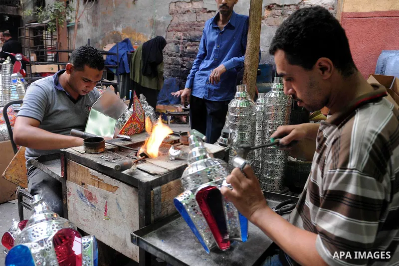 Egyptian men make traditional lanterns used for the holy month of Ramadan at a market in Cairo, Egypt, July 01, 2014. Muslim believers abstain from eating, drinking, smoking and having sex from dawn until sunset. Ramadan...