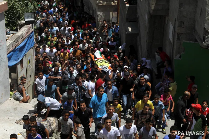 Mourners carry the body of Palestinian youth Yousef Abu Zagha, 20, during his funeral at the Jenin refugee camp, in Jenin, West Bank, 01 July 2014. Media reports citing locals and medics reports state the Israeli forces...