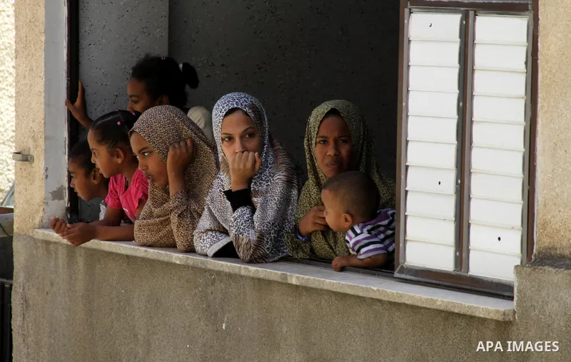 Women look at the body of Palestinian youth Yousef Abu Zagha, 20, during his funeral at the morgue of the Jenin refugee camp, in Jenin, West Bank, 01 July 2014. Media reports citing locals and medics reports state the Is...