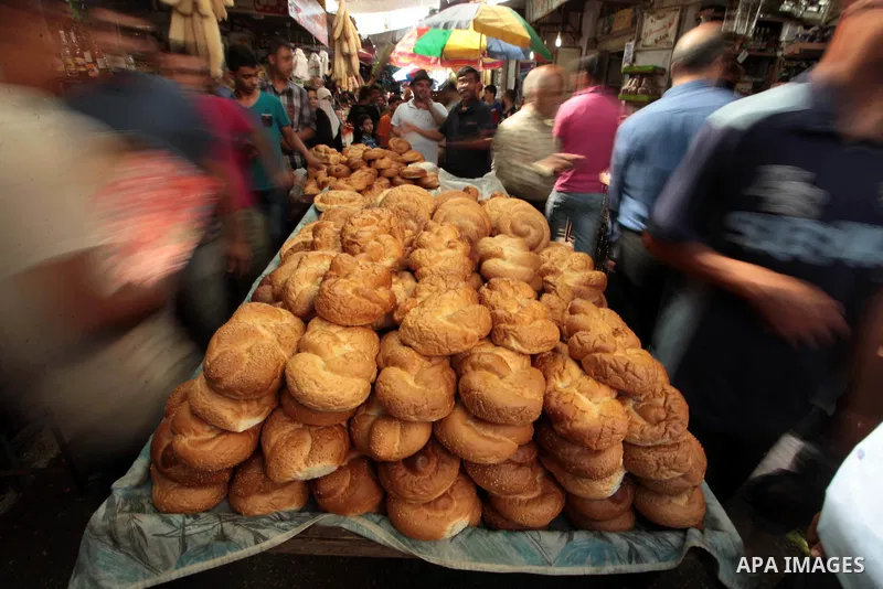 Palestinians buy bread at a street market during the holy fasting month of Ramadan in Gaza city, on July 01, 2014. Muslims around the world refrain from eating, drinking and sexual intercourse from dawn till dusk during...