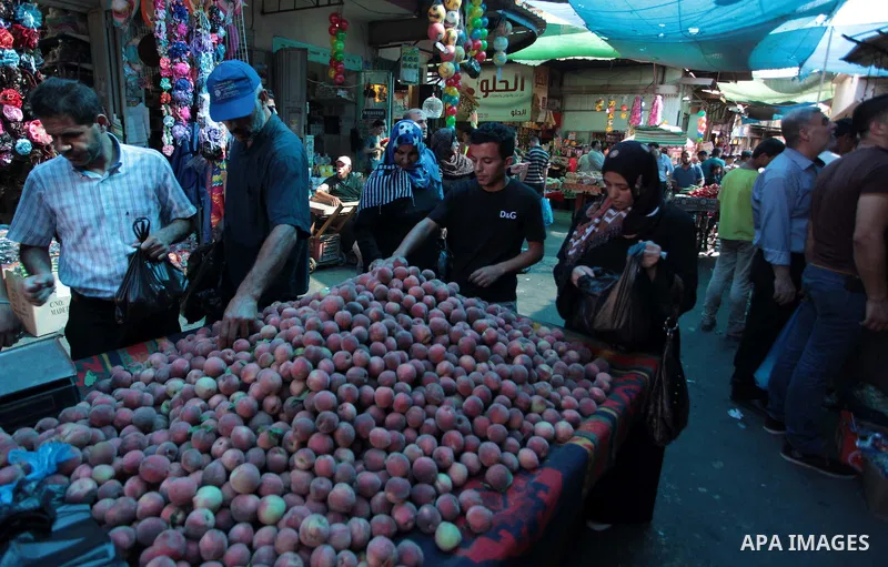 A Palestinian vendor sells peach at a street market during the holy fasting month of Ramadan in Gaza city, on July 01, 2014. Muslims around the world refrain from eating, drinking and sexual intercourse from dawn till du...