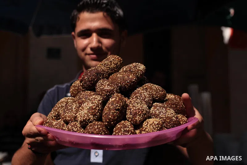 A Palestinian vendor sells falafel at a street market during the holy fasting month of Ramadan in Gaza city, on July 01, 2014. Muslims around the world refrain from eating, drinking and sexual intercourse from dawn till...