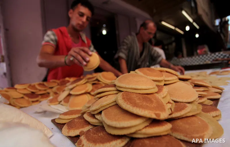 A Palestinian vendor prepares traditional pancakes known as ''Qatayef'' during the holy fasting month of Ramadan in Gaza city, on July 01, 2014. Muslims around the world refrain from eating, drinking and sexual intercour...