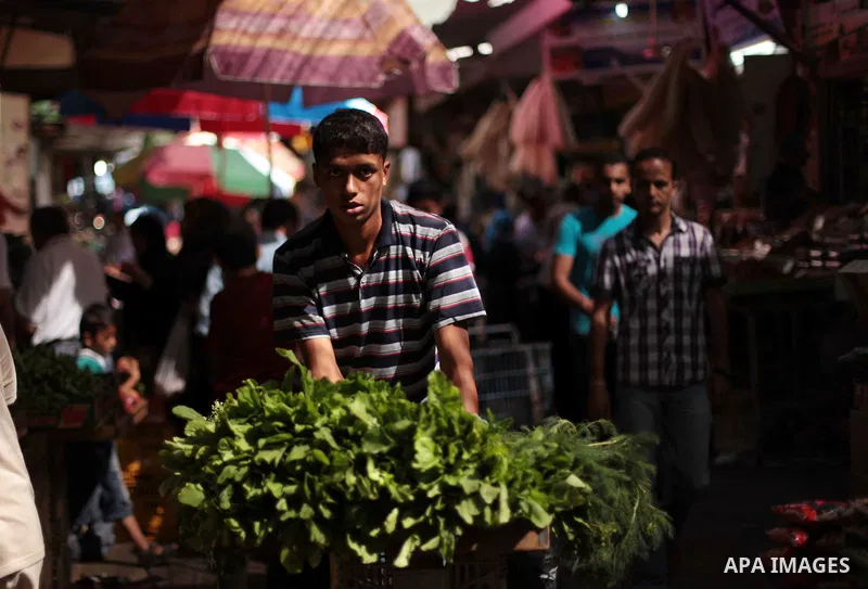 A Palestinian vendor sells greens at a street market during the holy fasting month of Ramadan in Gaza city, on July 01, 2014. Muslims around the world refrain from eating, drinking and sexual intercourse from dawn till d...