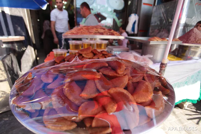 A Palestinian vendor sells traditional pancakes known as ''Qatayef'' during the holy fasting month of Ramadan in Gaza city, on July 01, 2014. Muslims around the world refrain from eating, drinking and sexual intercourse...