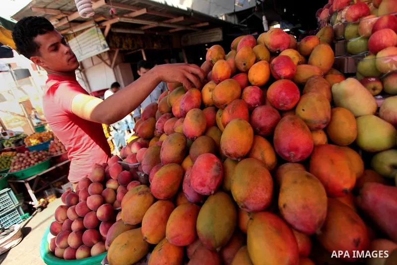A Palestinian vendor sells fruits at a street market during the holy fasting month of Ramadan in Gaza city, on July 01, 2014. Muslims around the world refrain from eating, drinking and sexual intercourse from dawn till d...