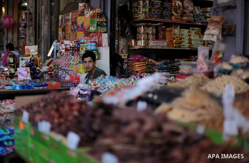 A Palestinian vendor sells candy at a street market during the holy fasting month of Ramadan in Gaza city, on July 01, 2014. Muslims around the world refrain from eating, drinking and sexual intercourse from dawn till du...