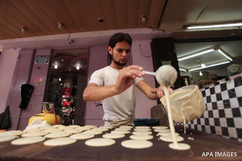 A Palestinian vendor prepares traditional pancakes known as ''Qatayef'' during the holy fasting month of Ramadan in Gaza city, on July 01, 2014. Muslims around the world refrain from eating, drinking and sexual intercour...