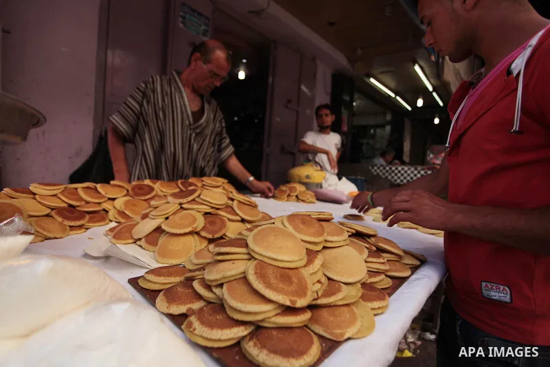 A Palestinian vendor prepares traditional pancakes known as ''Qatayef'' during the holy fasting month of Ramadan in Gaza city, on July 01, 2014. Muslims around the world refrain from eating, drinking and sexual intercour...
