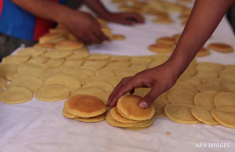 A Palestinian vendor prepares traditional pancakes known as ''Qatayef'' during the holy fasting month of Ramadan in Gaza city, on July 01, 2014. Muslims around the world refrain from eating, drinking and sexual intercour...