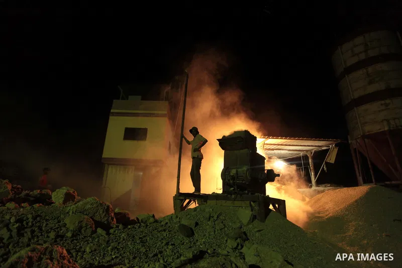 A Palestinian construction worker works at night in Deir al-Balah in central Gaza Strip on 2 July 2014. Palestinian construction workers work during the night in the month of Ramadan because of the high temperatures they...