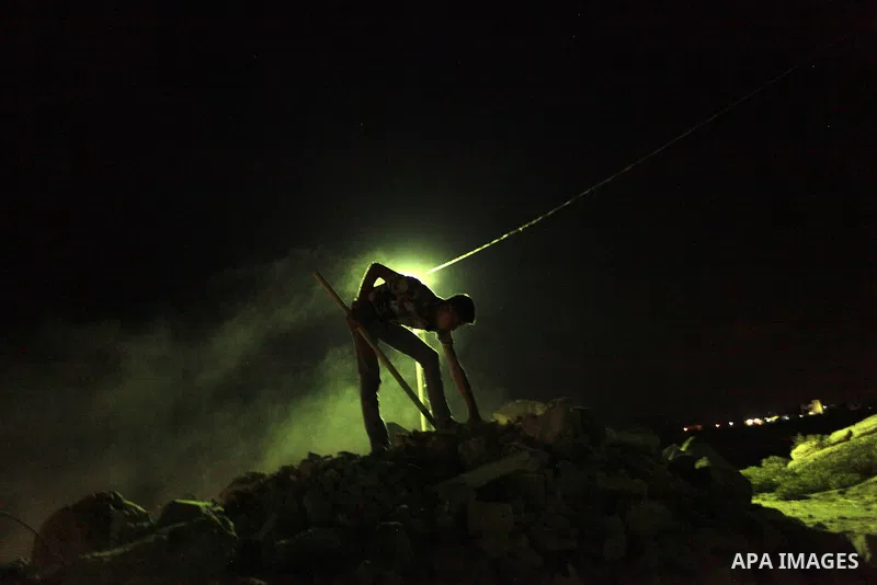 A Palestinian construction worker works at night in Deir al-Balah in central Gaza Strip on 2 July 2014. Palestinian construction workers work during the night in the month of Ramadan because of the high temperatures they...