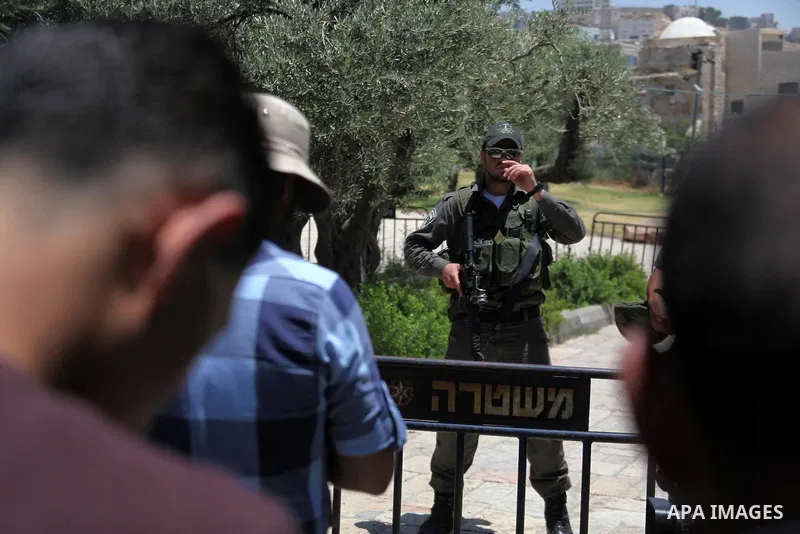 An Israeli policeman stands guard as Palestinian muslims attend the traditional Friday prayers, the first of Islam's holy month of Ramadan, at Ibrahimi mosque "Sanctuary of Abraham", in the West Bank City of Hebron July...