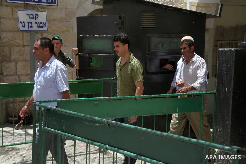 Israeli policemen stand guard as Palestinian muslims arrive at Ibrahimi mosque "Sanctuary of Abraham", to the traditional Friday prayers, the first of Islam's holy month of Ramadan, in the West Bank City of Hebron July 0...