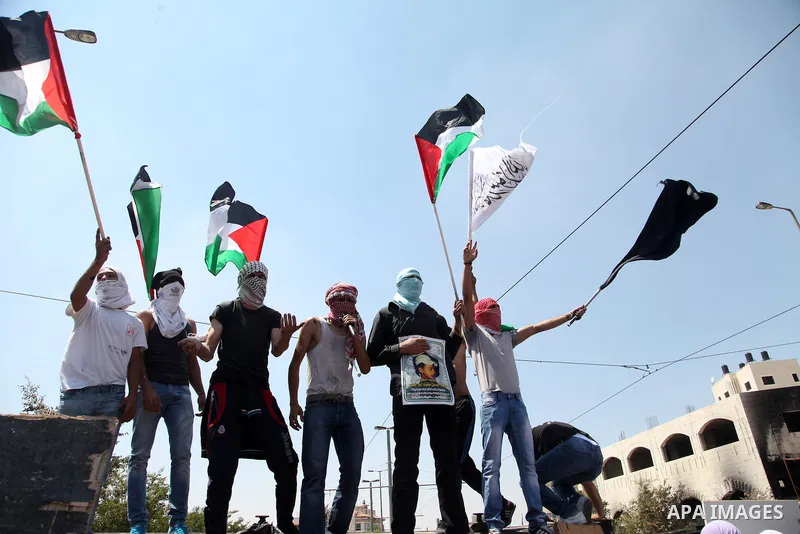 Thousands of mourners shout slogans as they gather for the funeral of Mohammed Abu Khder, 16, in Shuafat, in Israeli annexed East Jerusalem, on July 4, 2014. Abu Khder, a Palestinian teenager was reportedly kidnapped and...
