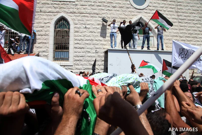 Palestinian mourners carry the body of Mohammed Abu Khder, 16, during his funeral in Shuafat, in Israeli annexed East Jerusalem on July 4, 2014. Abu Khder, a Palestinian teenager was reportedly kidnapped and killed, trig...