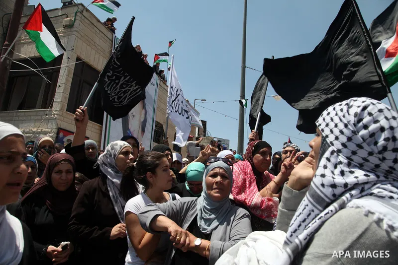 Thousands of mourners shout slogans as they gather for the funeral of Mohammed Abu Khder, 16, in Shuafat, in Israeli annexed East Jerusalem, on July 4, 2014. Abu Khder, a Palestinian teenager was reportedly kidnapped and...