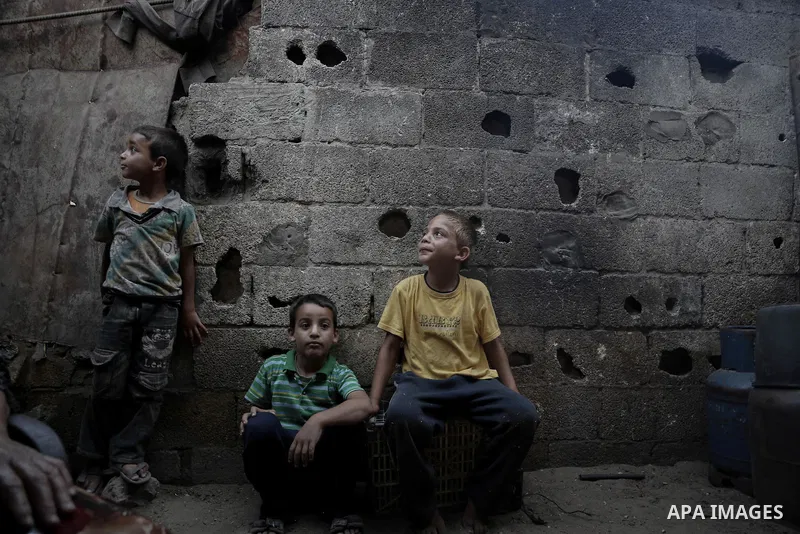 Palestinian children play outside their family's home in Beit Lahiya, northern Gaza Strip, July 5, 2014. Muslims around the world are observing the holy fasting month of Ramadan in which they refrain from eating, drinkin...