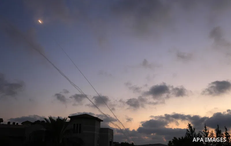 Fire ball and smoke trails are seen as a rocket is launched from the east Gaza City towards Israel on July 07, 2014. Israeli air strikes on Gaza, that killed at least seven Palestinian militants overnight, came after a d...