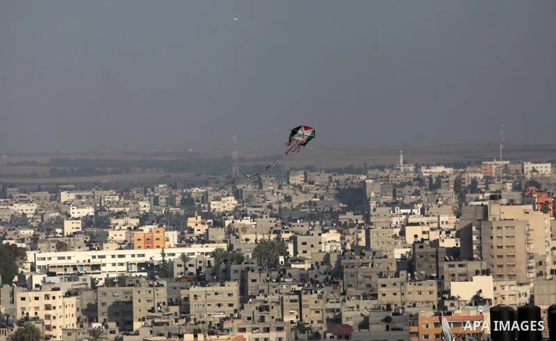 A kite with Palestinian flag colors is seen flying over Gaza City on July 07, 2014. Israeli air strikes on Gaza, that killed at least seven Palestinian militants overnight, came after a day in which armed groups fired at...